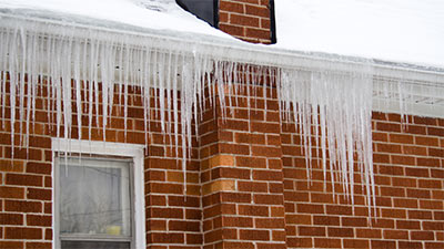 Icicles hanging from roofs gutter