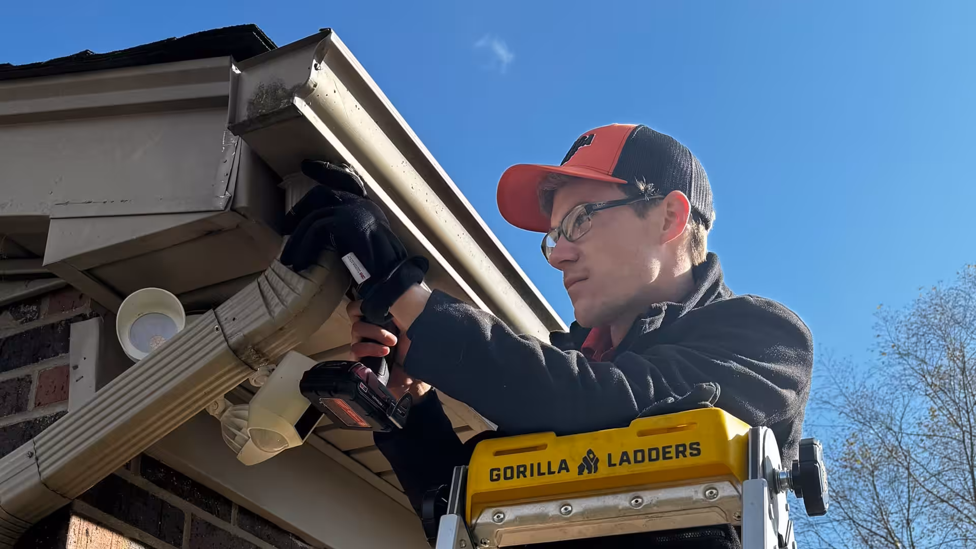 A Brandstetter's KangaRoof team member skillfully replaces gutters on a residential home in Greater Cincinnati