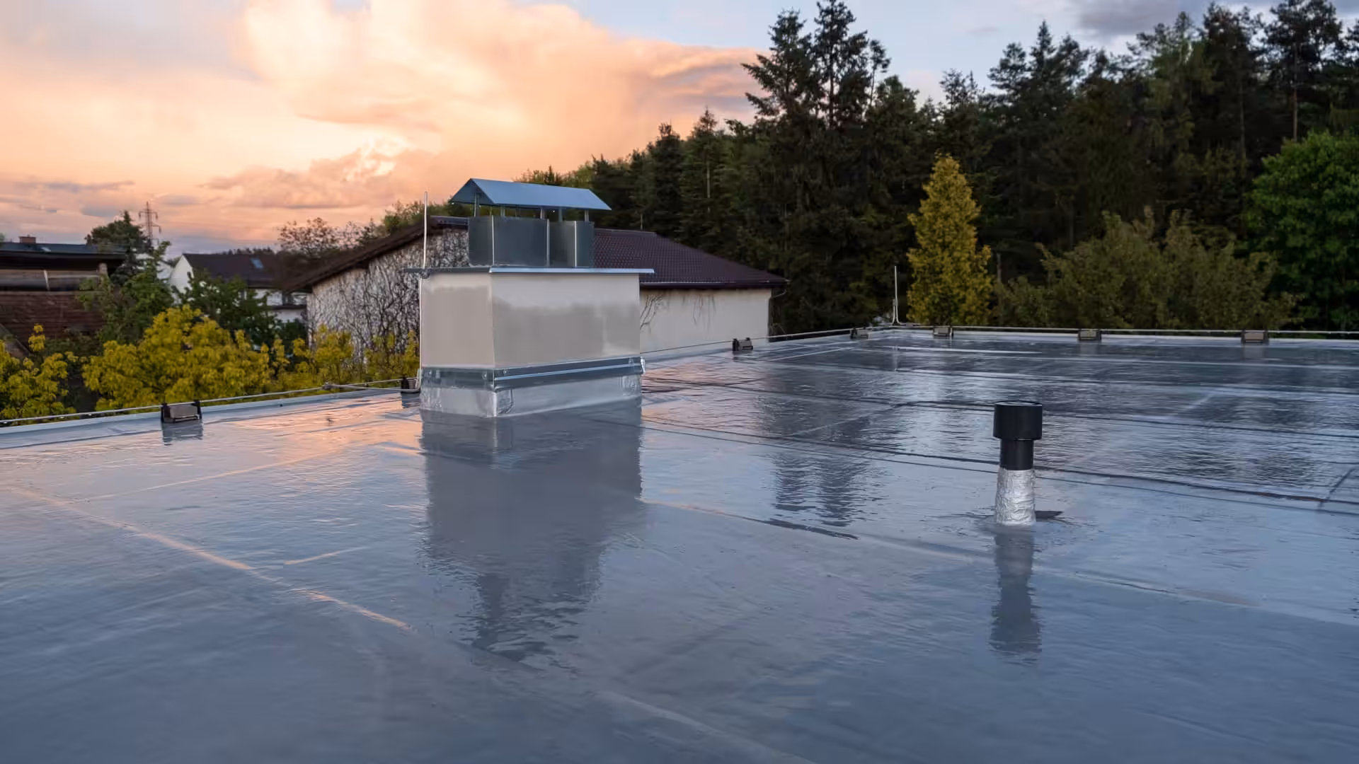 A new flat roof system installed on a large residential building.