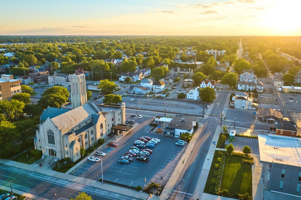Aerial photo of Muncie, Indiana with a church in the foreground at sunset in Eastern Indiana
