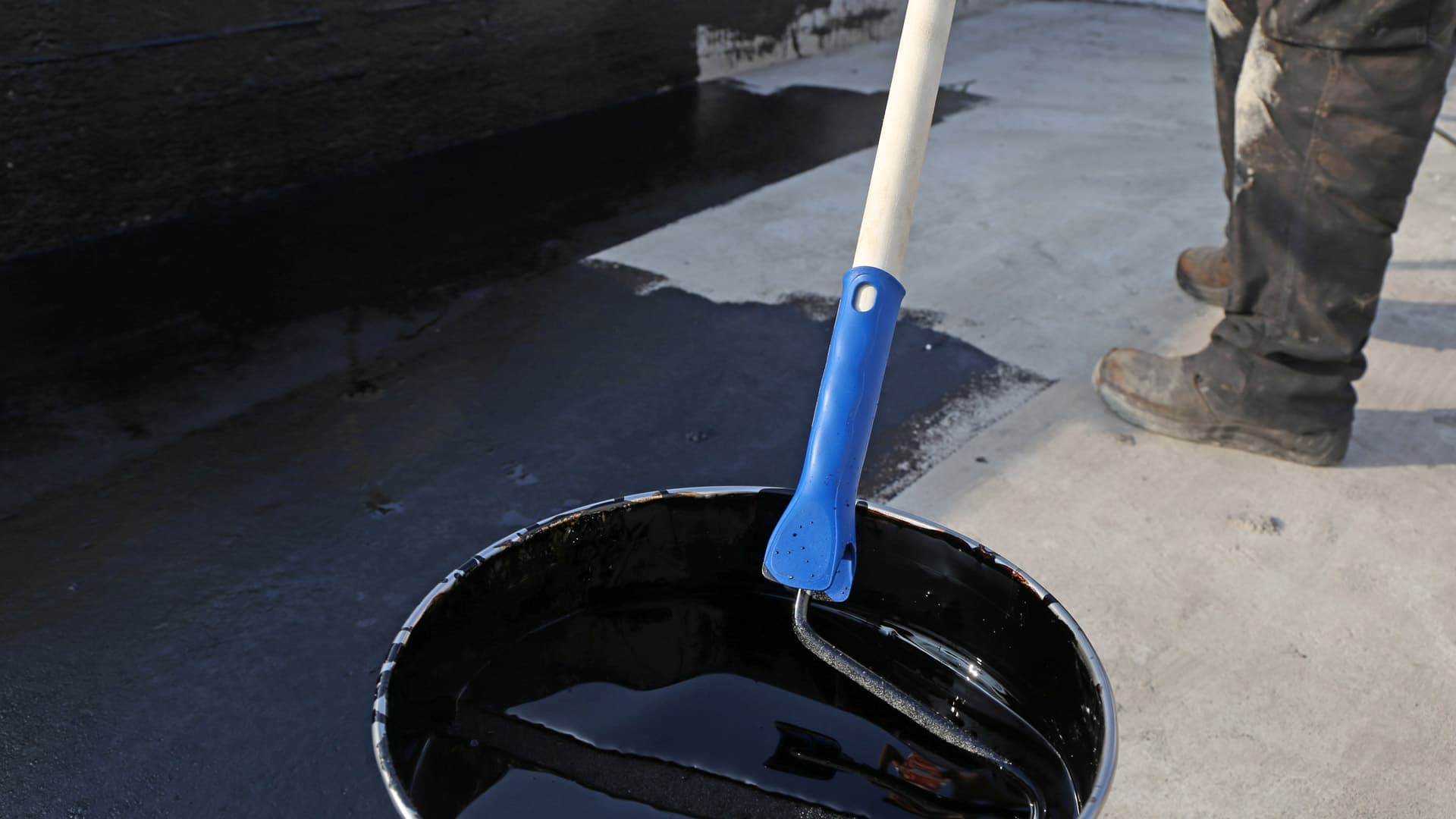 A freshly opened bucket of rubberized roof coating.