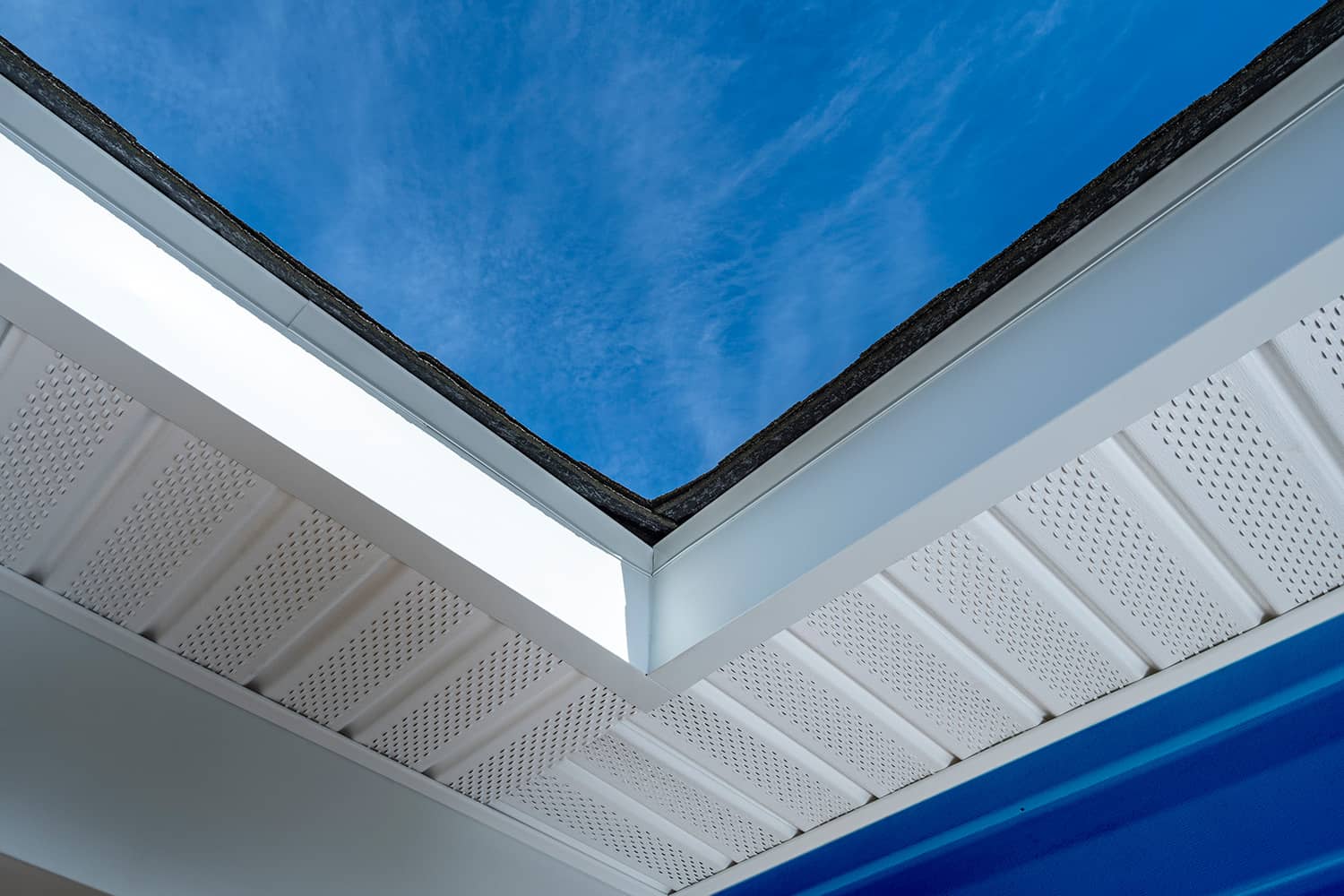 A picture focusing on soffit on the underside of a gutter system.